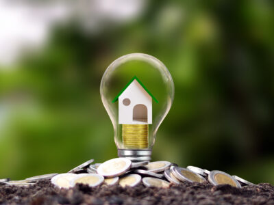 model-houses-are-piles-coins-energy-saving-lamps-energy-saving-concept-renewable-energy-real-estate-investment-loans